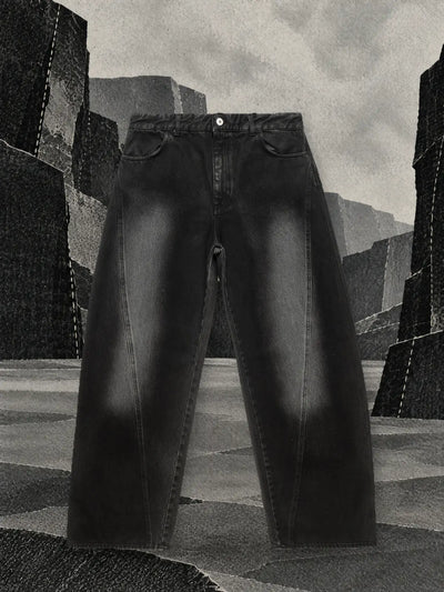 The faded black jeans in a canyon with walls of black and grey paper.