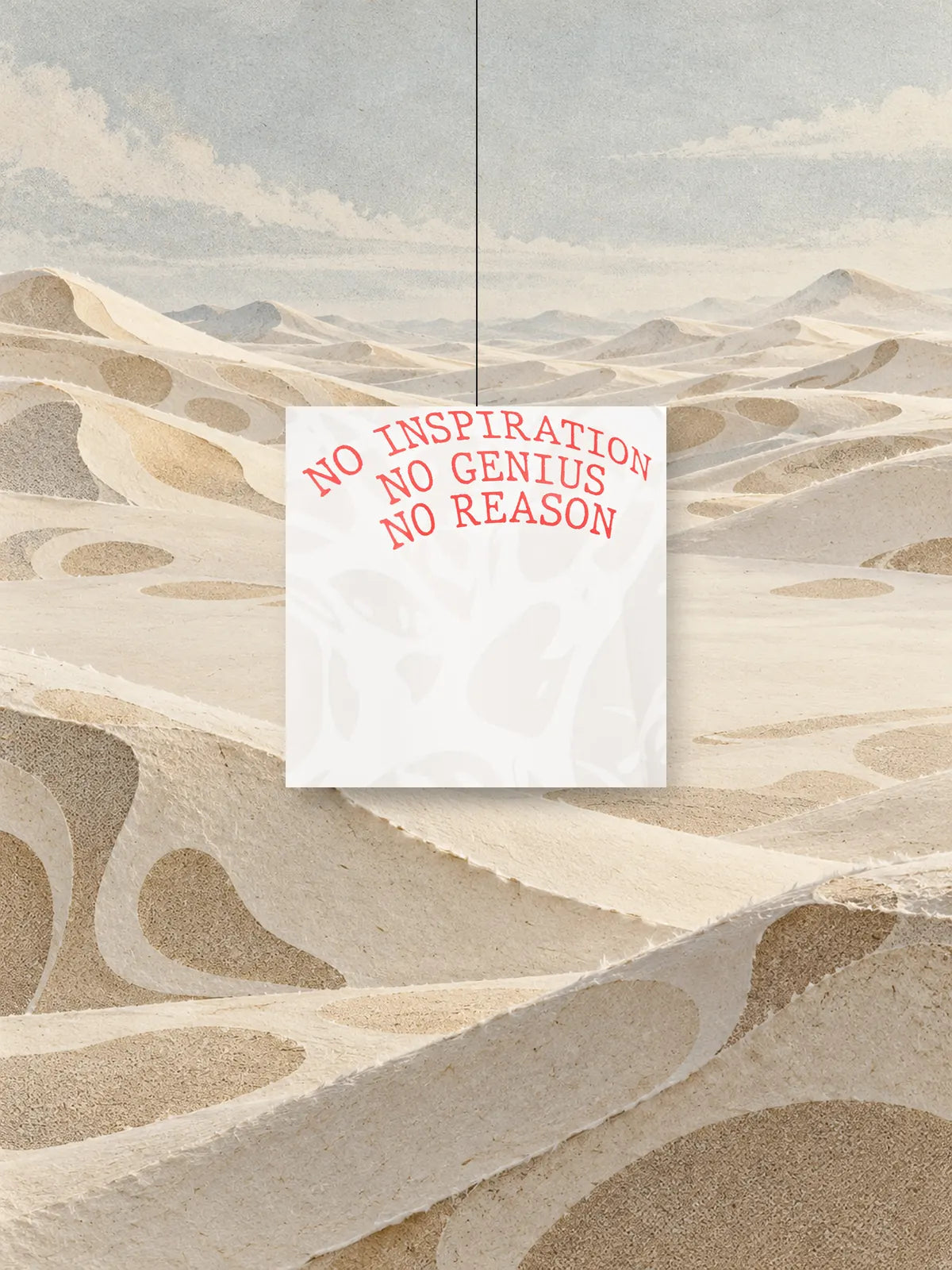 Een vierkant, uitgeknipt uit de print van de Strand Ivory sweater, met de rode tekst NO INSPIRATION NO GENIUS NO REASON, aan een draad boven duinen van ivoorkleurig papier.