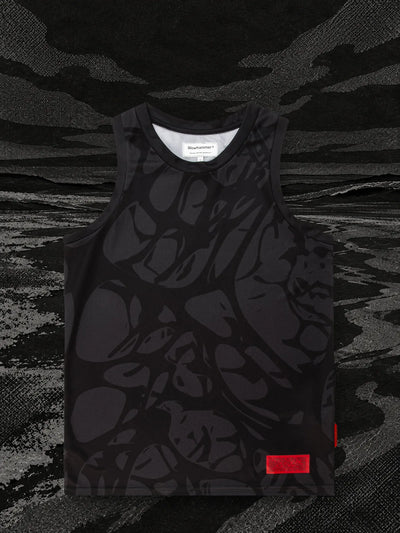 The black Strand tank top on the shore of a sea of black and grey paper.