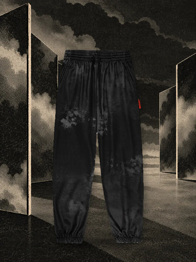 The black Triodrome joggers among dark paper panels reflected in the water, in the fog.